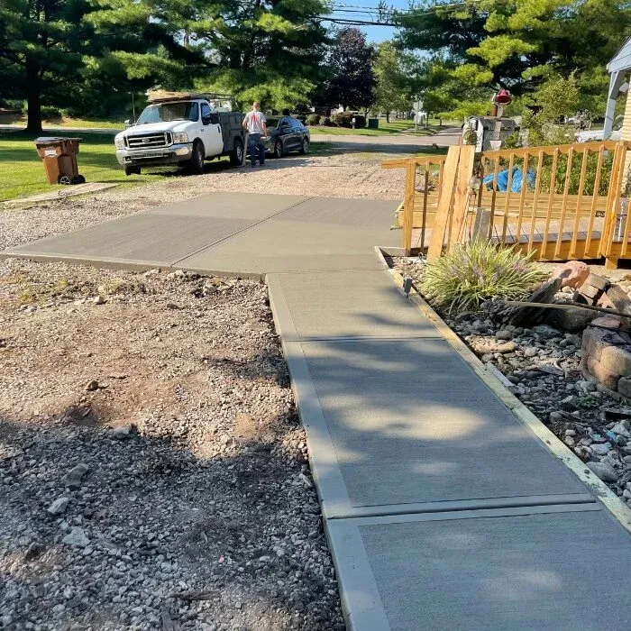 New concrete driveway and connecting walkway at a residential property