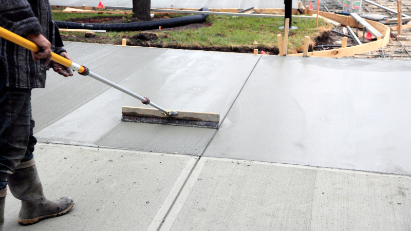 Concrete driveway contractors in Cincinnati smoothing and finishing new driveway surface.