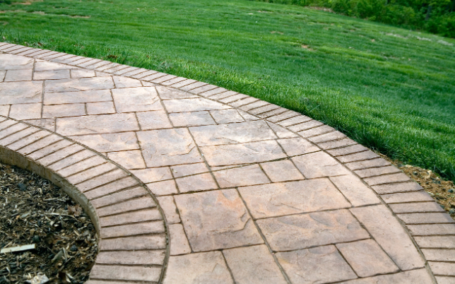 Stylish and modern stamped concrete pathway in Cincinnati featuring cobblestone pattern.